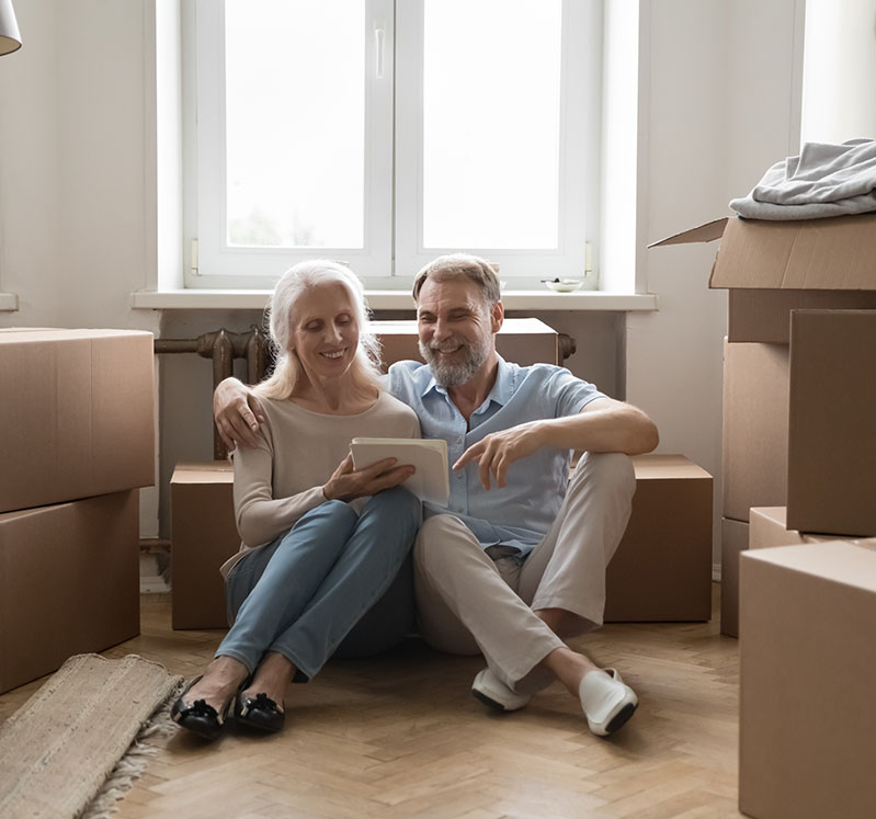 Image showing a couple sitting on the floor surrounded by boxes