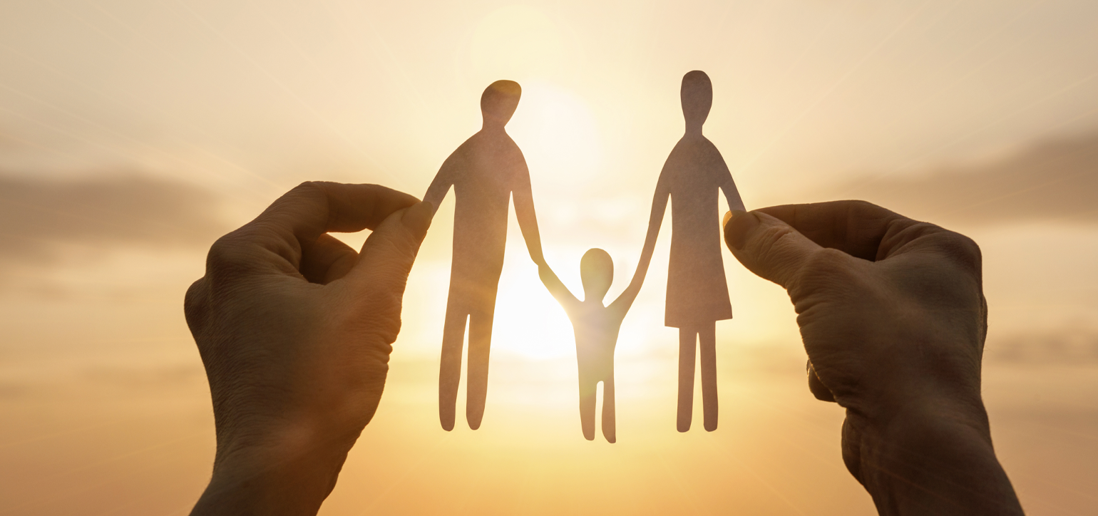 hands holding paper shaped as a family