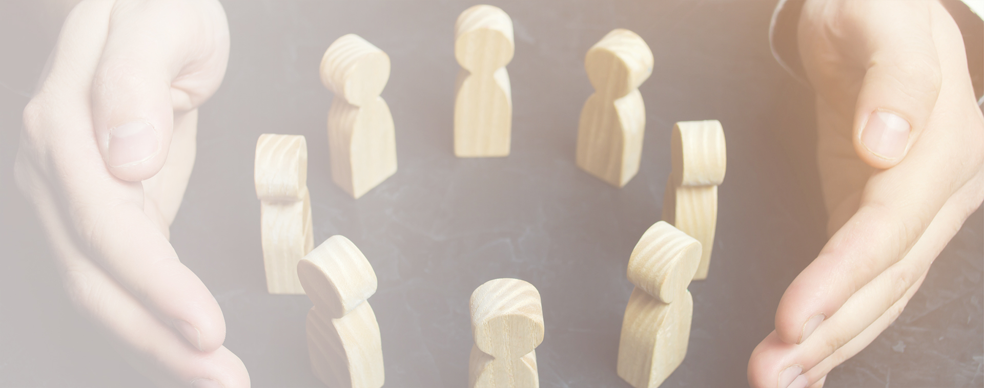 Image showing a pair of hands protecting a cirlce of wooden figures