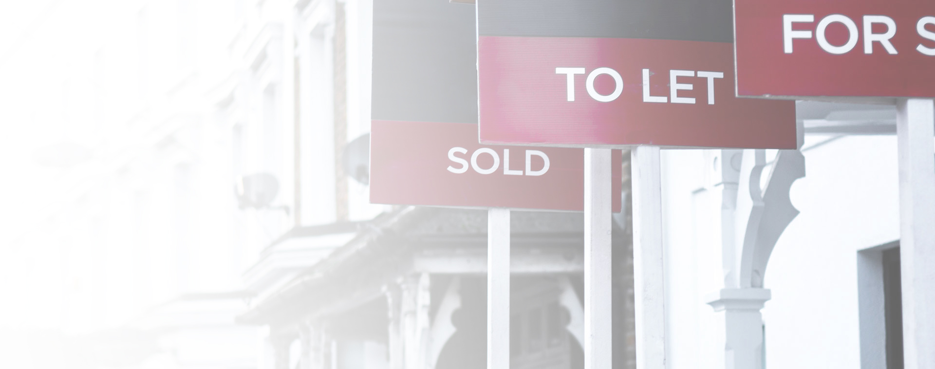 Image showing a close up of various estate agent boards on a row of white houses