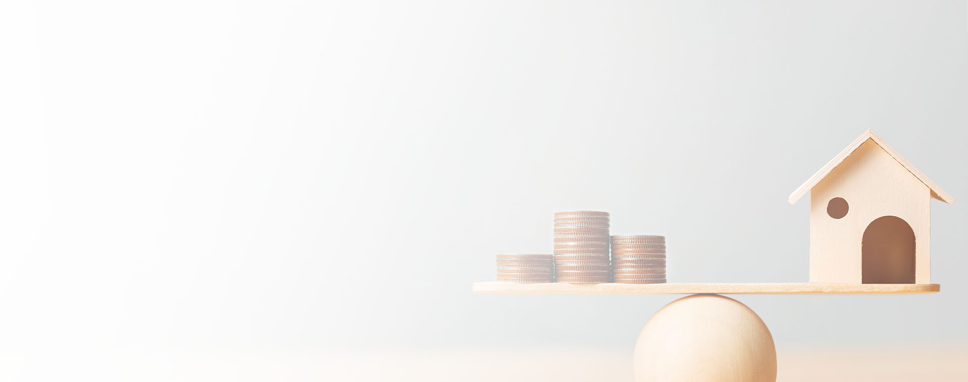 Image showing a balance beam with coins on one side and a model house on the other