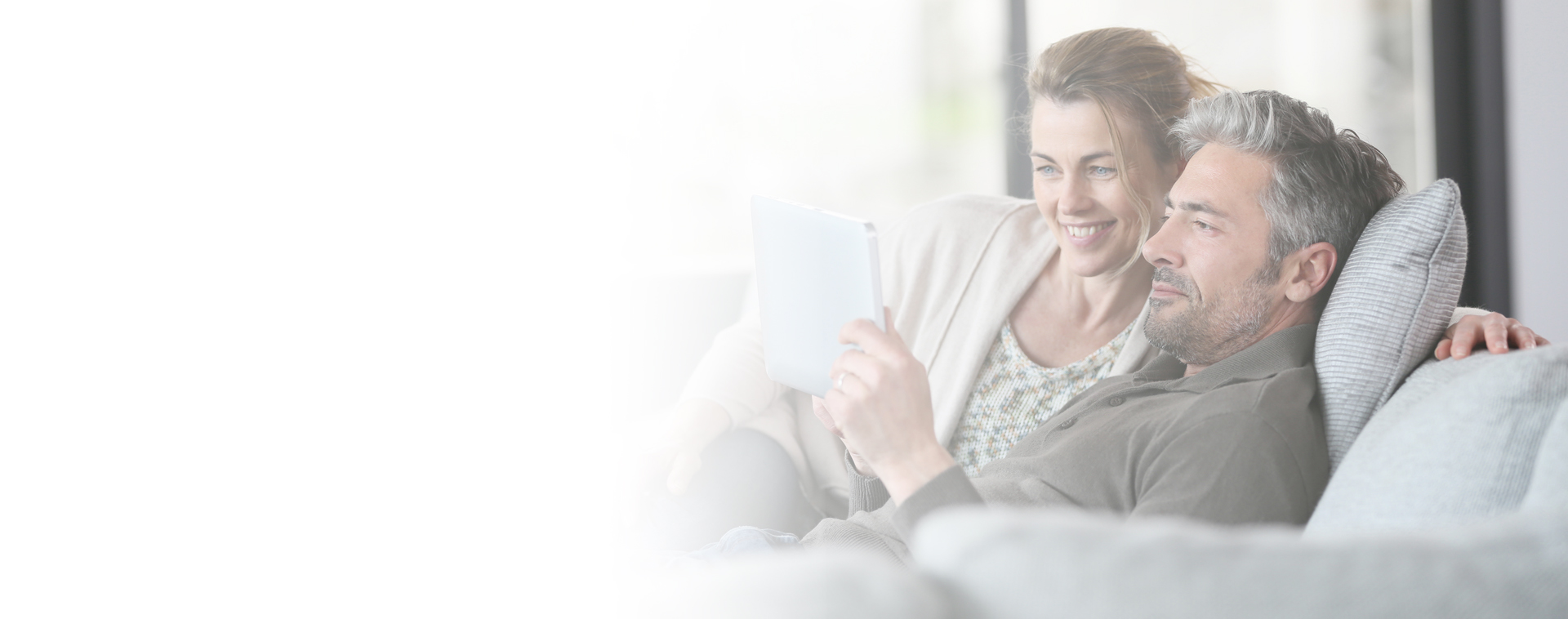 Image showing a couple looking at a tablet and relaxing