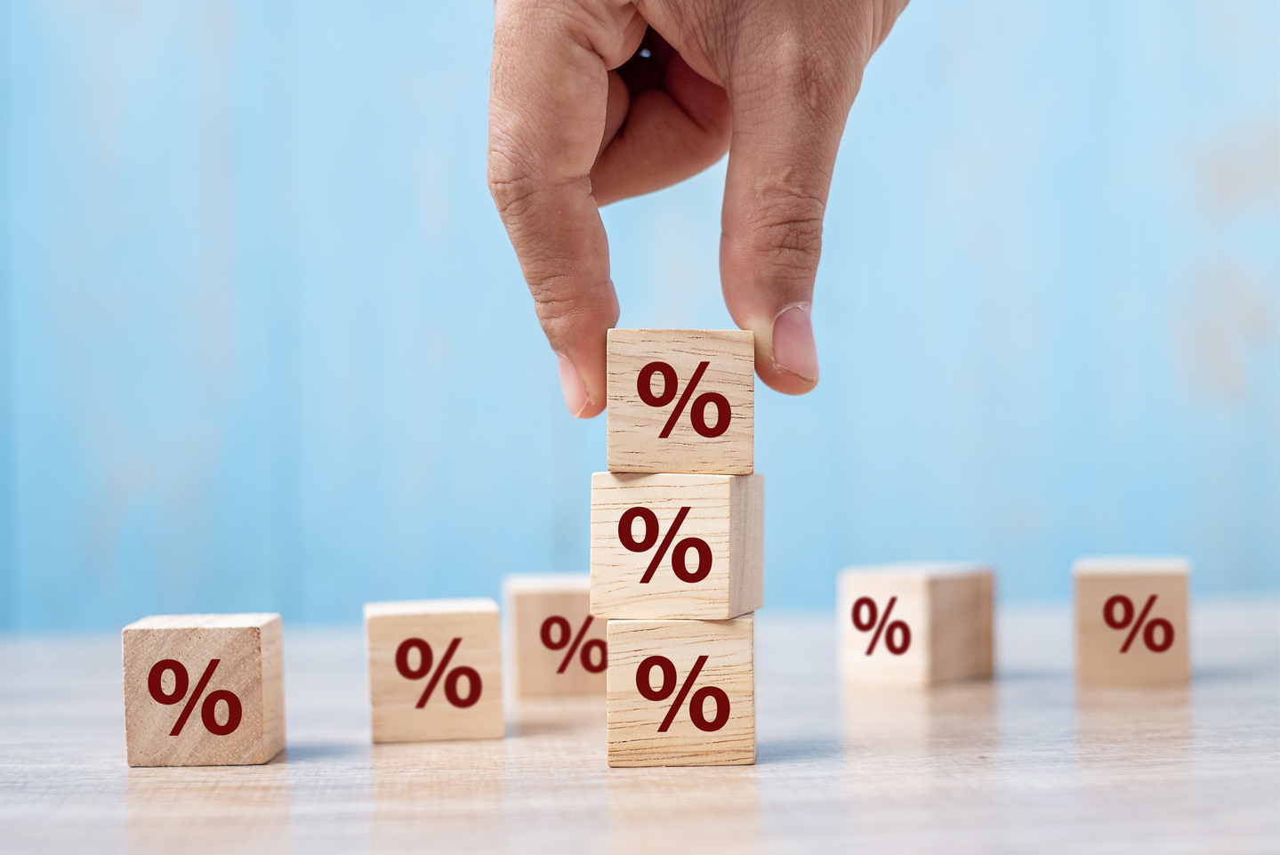 Image showing business man hand putting wood cube block with percentage symbol icon