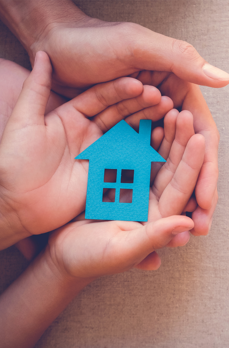 image showing hands holding blue paper house