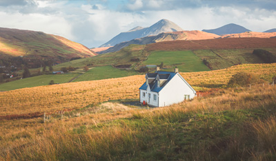White croft house cottage in a rural mountain landscape countryside